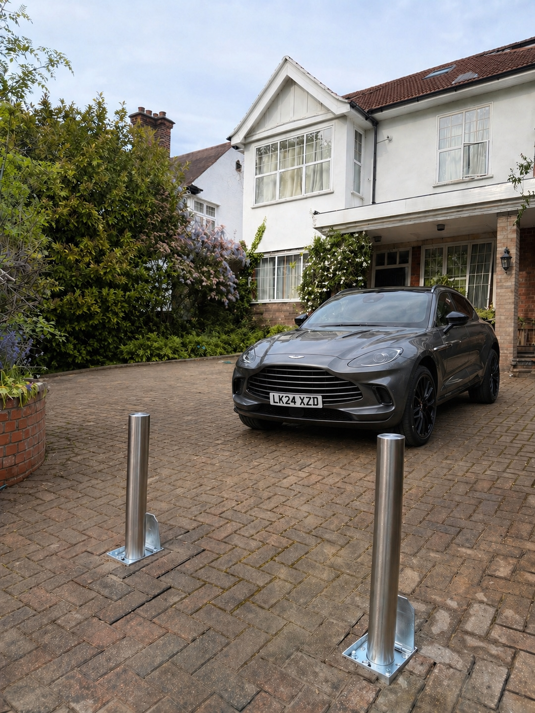 Same London driveway after telescopic bollard installation — Aston Martin protected