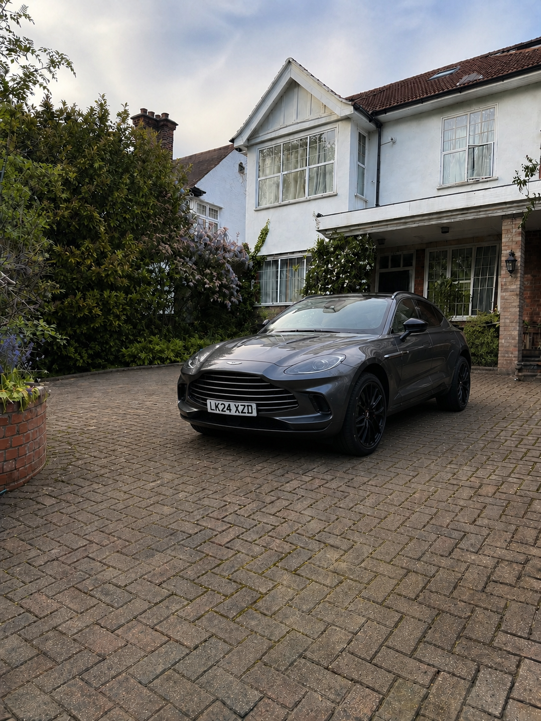 London driveway before bollard installation — Aston Martin parked unprotected